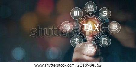 Tax deduction planning concept, expenses, accounting, value added tax, income tax and property tax. Paying taxes. Hands of businessman in dark with technology light.