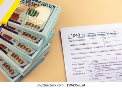 TAX DEDUCTIONS And Individual Tax Return Form On Table. Tax Form With Money On Table. Lodging Your Tax Return