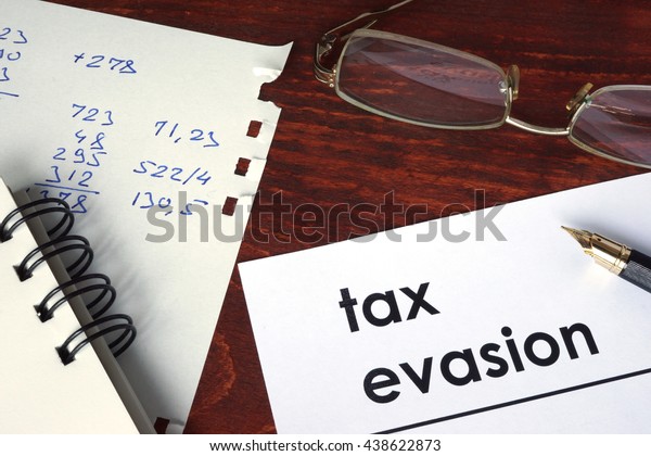 Tax evasion written on a\
paper. 