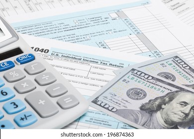 Tax Form 1040 with calculator and US dollars