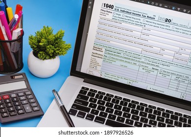 Tax Form 1040 On Laptop Screen. On Light Blue Background