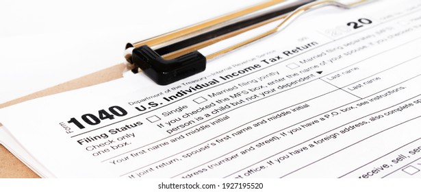 Tax form 1040 for tax year 2012 for US individual tax return with pen - Shutterstock ID 1927195520