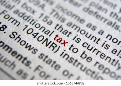 Tax form business financial concept with Close-Up TAX on red - Shutterstock ID 1563744982