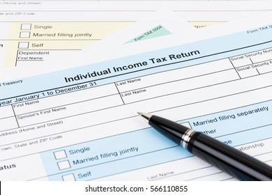 Tax form with pen; document are mock-up - Shutterstock ID 566110855