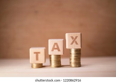 Tax Increase Illustrated With Wooden Cubes And Coins