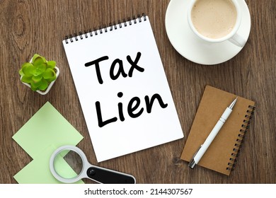 Tax Lien. Notepad On A Wooden Background With Text