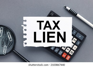 Tax Lien. Text On Paper On Calculator On Wood Table