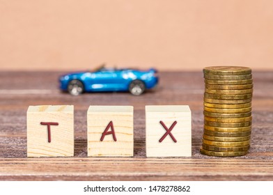 The Tax On Cars, Concept Taxes On Cars, Selective Focus, Wood Background And A Blurred Car In The Background