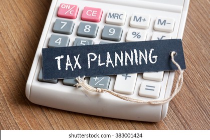 Tax Planning words written on label with calculator,Business Concept