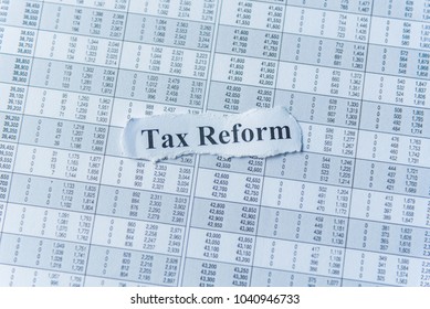 Tax Reform written on sticky notes paper reminder with financial number. Checking balance, preparation of a balance sheet. Calculating number for income tax return.