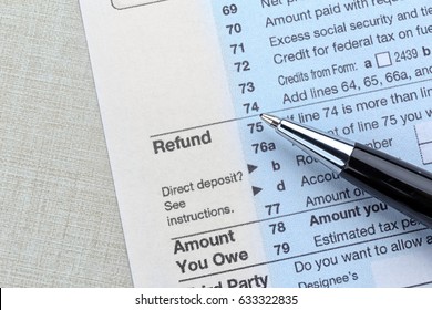 Tax refund document and pen on light background