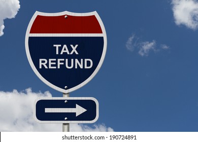 Tax Refund this way, Blue and Red Interstate Sign with word Tax Refund and an arrow with sky background