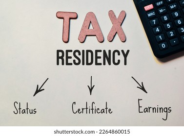 Tax residency text and flowchart with calculator on desk.