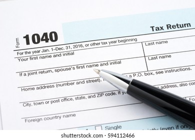 Tax return blank, calculator and pen - Shutterstock ID 594112466