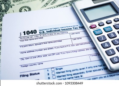 Tax Return form 1040 and dollar banknote : U.S. Individual Income.