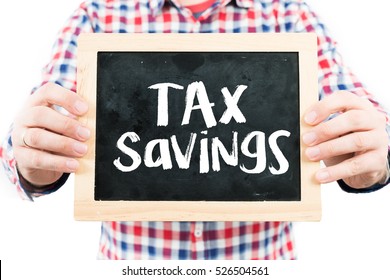 Tax Savings / Man Holding Small Blackboard.