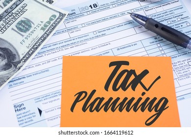 Tax Or Taxation Concept. The Tax Form Is For US Citizens And Internationals Staying In The USA To File Their Tax Return With An Orange Note Written Tax Planning