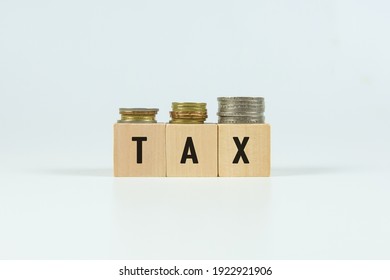 TAX text on wooden block with white backgrounds.