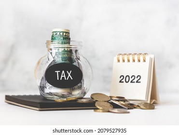 Tax Time In 2022. Glass Money Box With Money