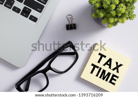 Tax Time concept on the sticky note paper.