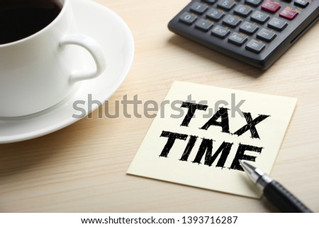 Tax Time concept on the sticky note paper.