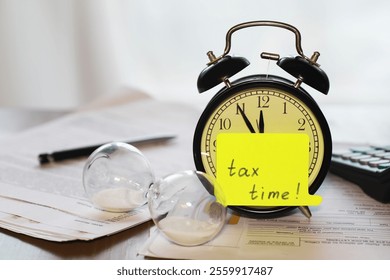 Tax Time Reminder - Alarm Clock, Hourglass, Calculator and Tax Documents for Financial Deadlines - Powered by Shutterstock