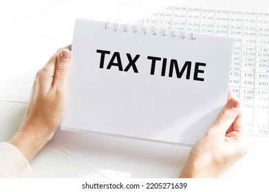 Tax Time Text On A Notebook In The Hands Of A Businessman On The Background Of An Office Desk