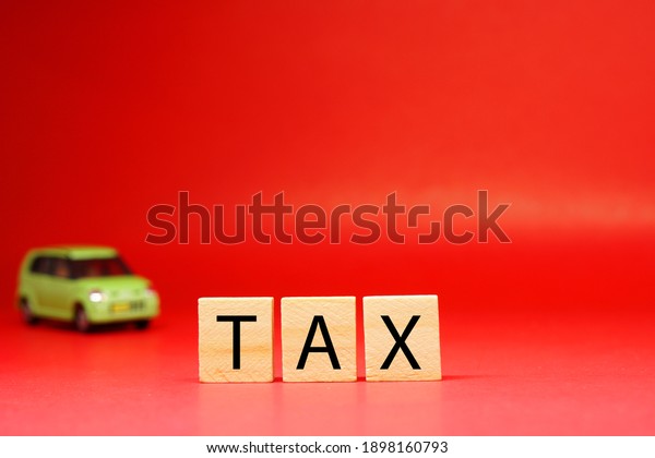 Tax word on blur car or\
vehicle  background - Red pattern of Business and Planning cost\
investment concept - Calculate Reduce Taxes or Taxes back and\
return 2021