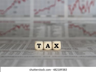 Tax word on business newspaper background