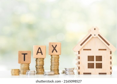 Tax wording print screen to wooden cube block on growing coin stacking for increasing of taxation concept. - Shutterstock ID 2165098527