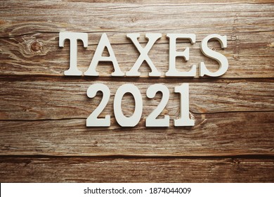 Taxes 2021 Alphabet Letter On Wooden Background