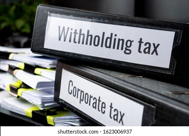 taxes binders concept: Document of Withholding tax and corporate tax for accountant. withholding tax sometimes applies to royalties, rent or even sale of real estate, duty must be paid to government - Shutterstock ID 1623006937