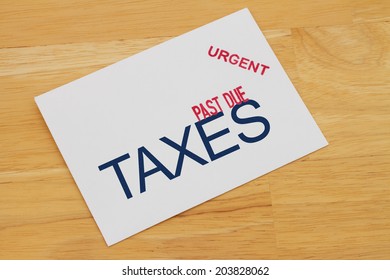 Taxes Past Due Envelop With Past Due And Urgent Stamps On A Wooden Desk