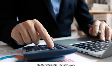 Taxes refund and calculation government tax return concept. Accountant using laptop and calculator for calculate finance report in office, Auditor vat document spreadsheet, revenue asset increase. - Shutterstock ID 2292612675