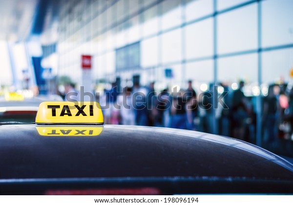 Taxi car waiting arrival passengers in front of\
Airport Gate