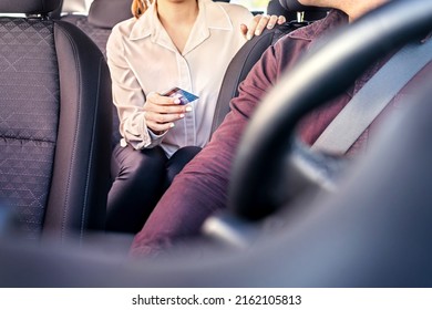 Taxi and card payment. Customer paying cab fare. Woman giving money to driver. Transaction security, scam or fraud concept. Passenger purchase ride service or business commute. Bank credit and wallet.