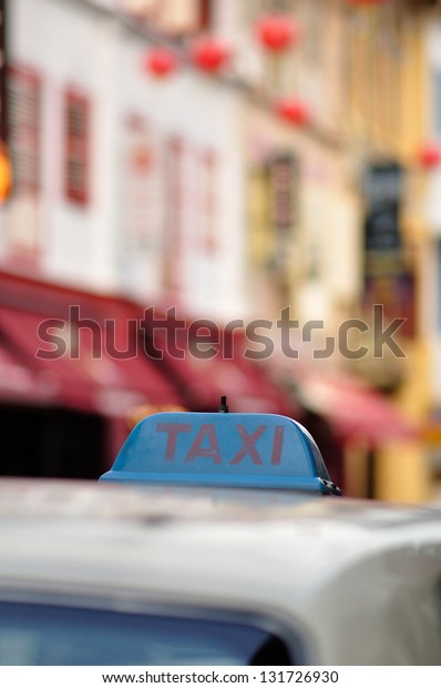 Taxi in China town, Singapore with taxi markings\
visible and selective\
focus