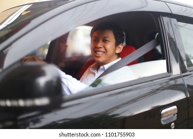 taxi driver with face asian man smiling. Handsome taxi driver sitting in car. yogyakarta indonesia. may 31, 2018