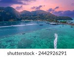 Taxi long tail boat to Phi Phi island, Krabi Province, Thailand sunset Aerial top view. Travel Thai vacation on tropical place with resorts.