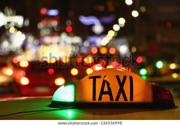Taxi at night with lights signal system works.\
Yellow cab in Bucharest,\
Romania.