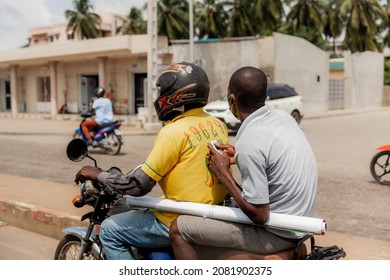 Taxi ride in Cotonou, Benin on a motorcycle.