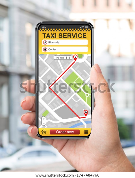 Taxi service online app. Man hand\
holding cell phone with map for destination\
place