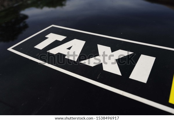 Taxi sign on black background\
