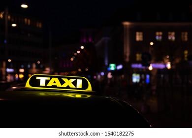 Taxi Sign On Top Of A Car, Glowing Night Urban