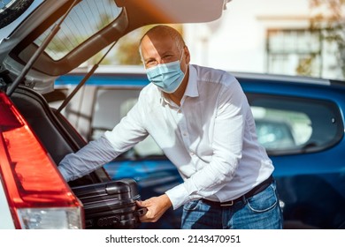 A Taxi Or Uber Driver Unloading The Luggage From The Trunk Of His Car 