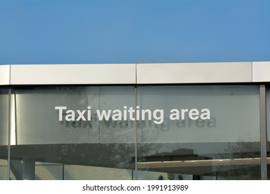 Taxi Waiting Area Sign On The Side Of A Modern Building