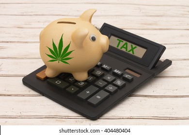 Taxing the sale of marijuana, A golden piggy bank and calculator on a wood background with a marijuana leaf