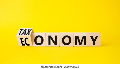 Taxonomy And Economy Symbol. Turned Cubes With Words Economy And Taxonomy. Beautiful Yellow Background. Business And Taxonomy And Economy Concept. Copy Space