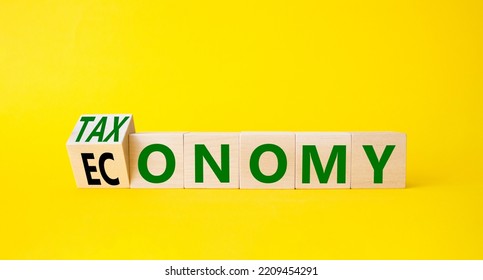 Taxonomy And Economy Symbol. Turned Cubes With Words Economy And Taxonomy. Beautiful Yellow Background. Business And Taxonomy And Economy Concept. Copy Space