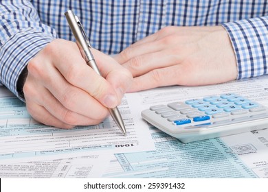 Taxpayer Filling Out 1040 Tax Form